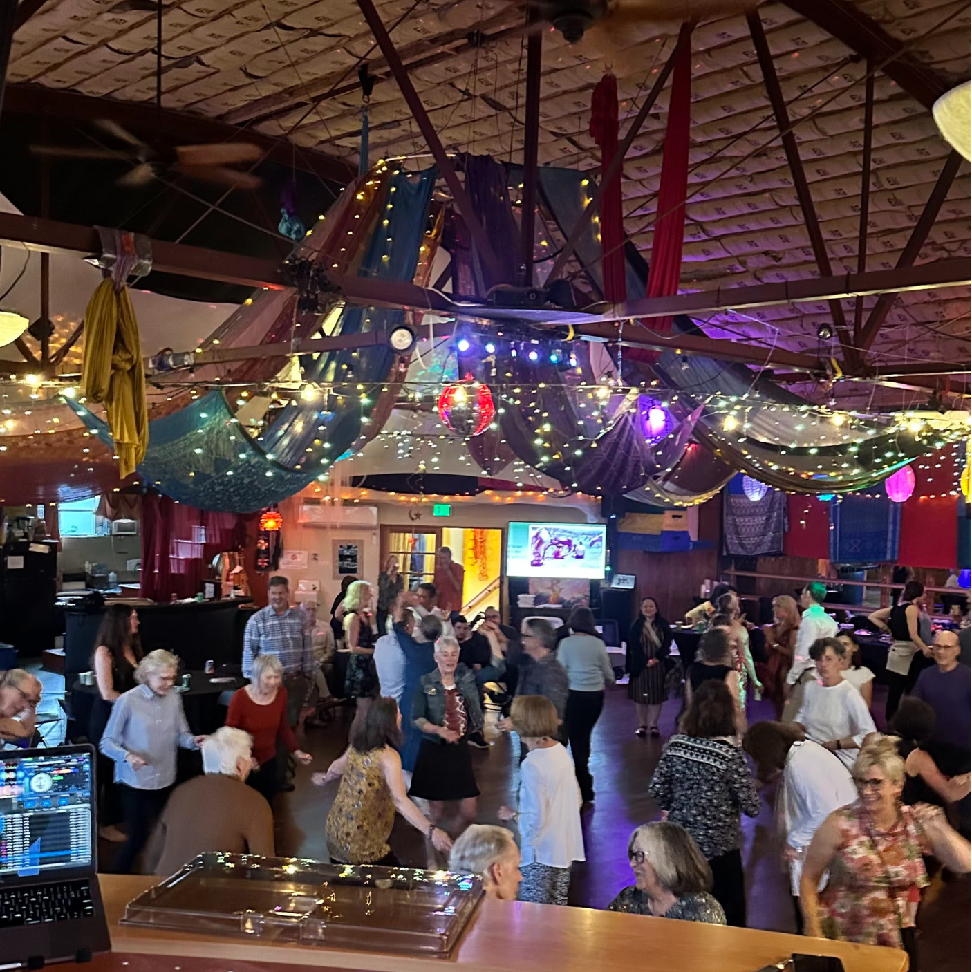 Guests dancing and celebrating at "Healing through Movement: Carol’s Book Launch & Birthday Bash" — an event blending joy, community, and trauma healing through movement.